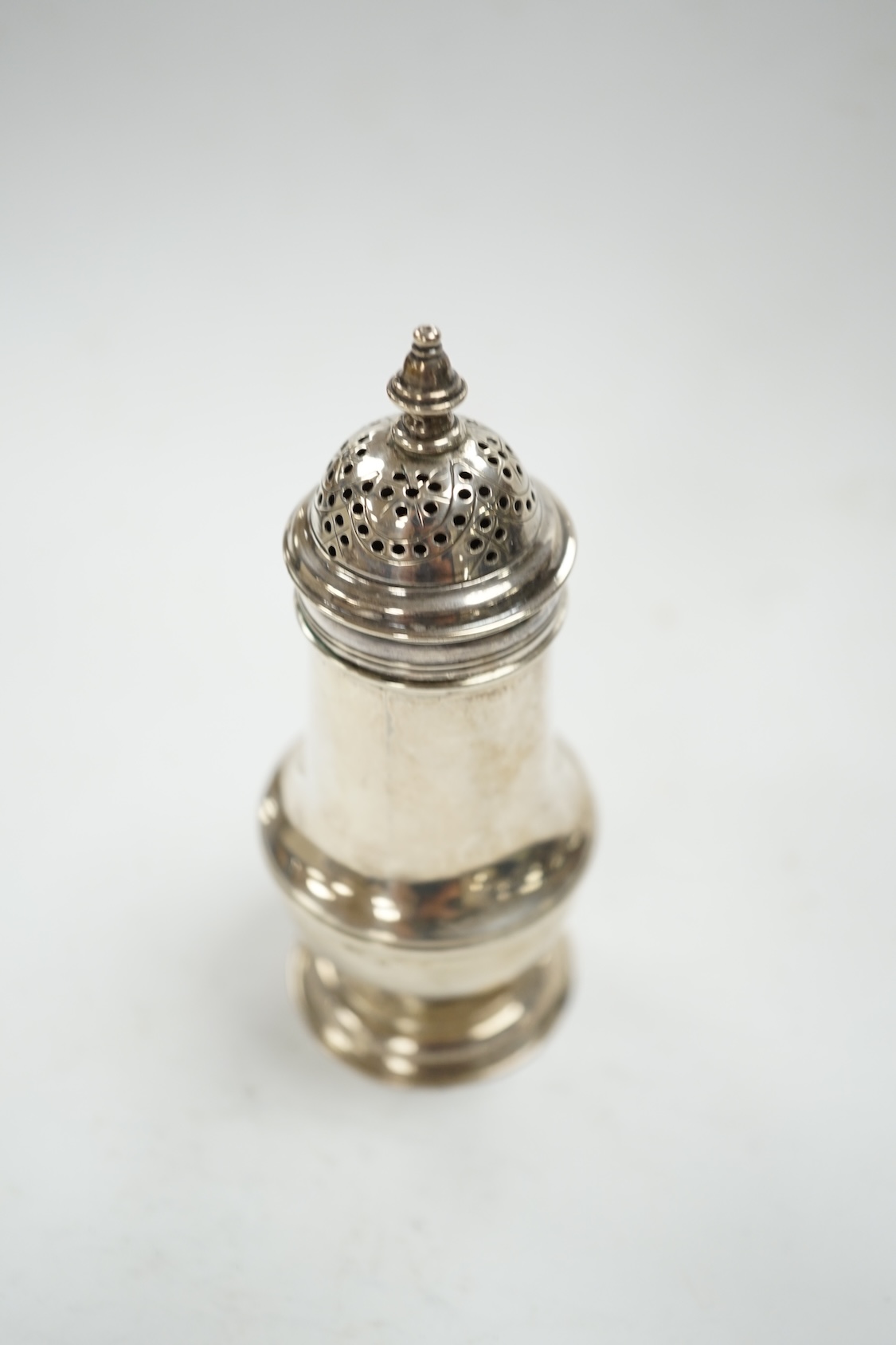 A George III silver baluster pepperette, by Samuel Wood, London, 1768, 10.7cm (cover unmarked). Condition - fair